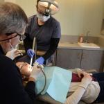 Dr. Gardner working on a patient with staff assisting- photo angled from doctor