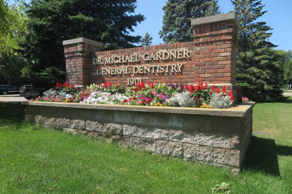 Outdoor office photo of the practice name on a brick structure
