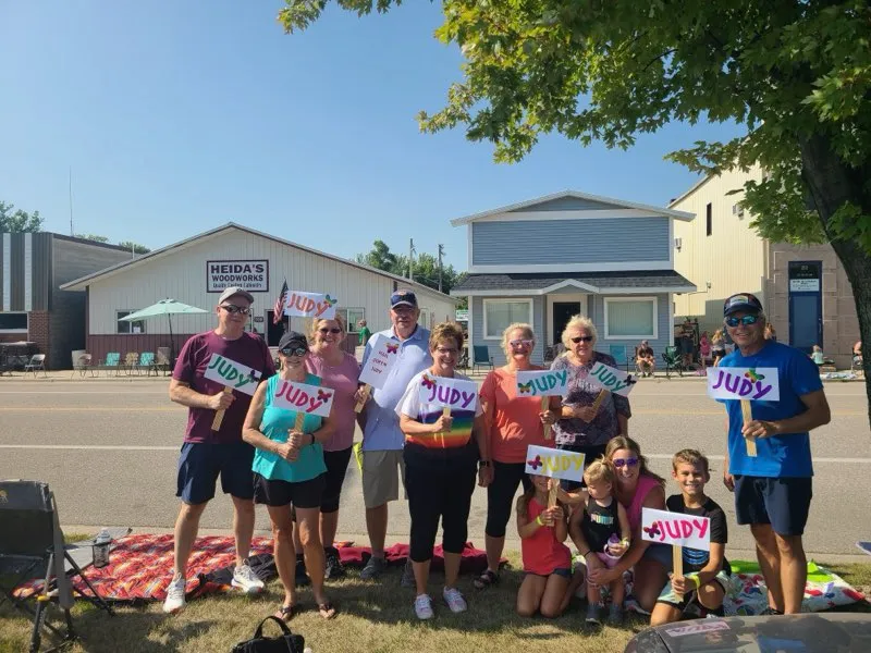 A group photo of families and participants gathered together at an outdoor event, featured on the Willmar Dental page.