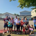 A group photo of families and participants gathered together at an outdoor event, featured on the Willmar Dental page.