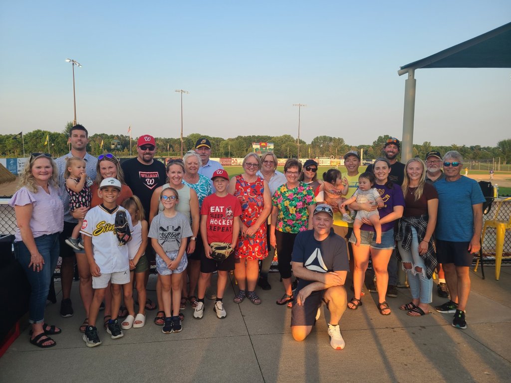 A group photo of families and participants gathered together at an outdoor event, featured on the Willmar Dental page.