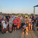 A group photo of families and participants gathered together at an outdoor event, featured on the Willmar Dental page.